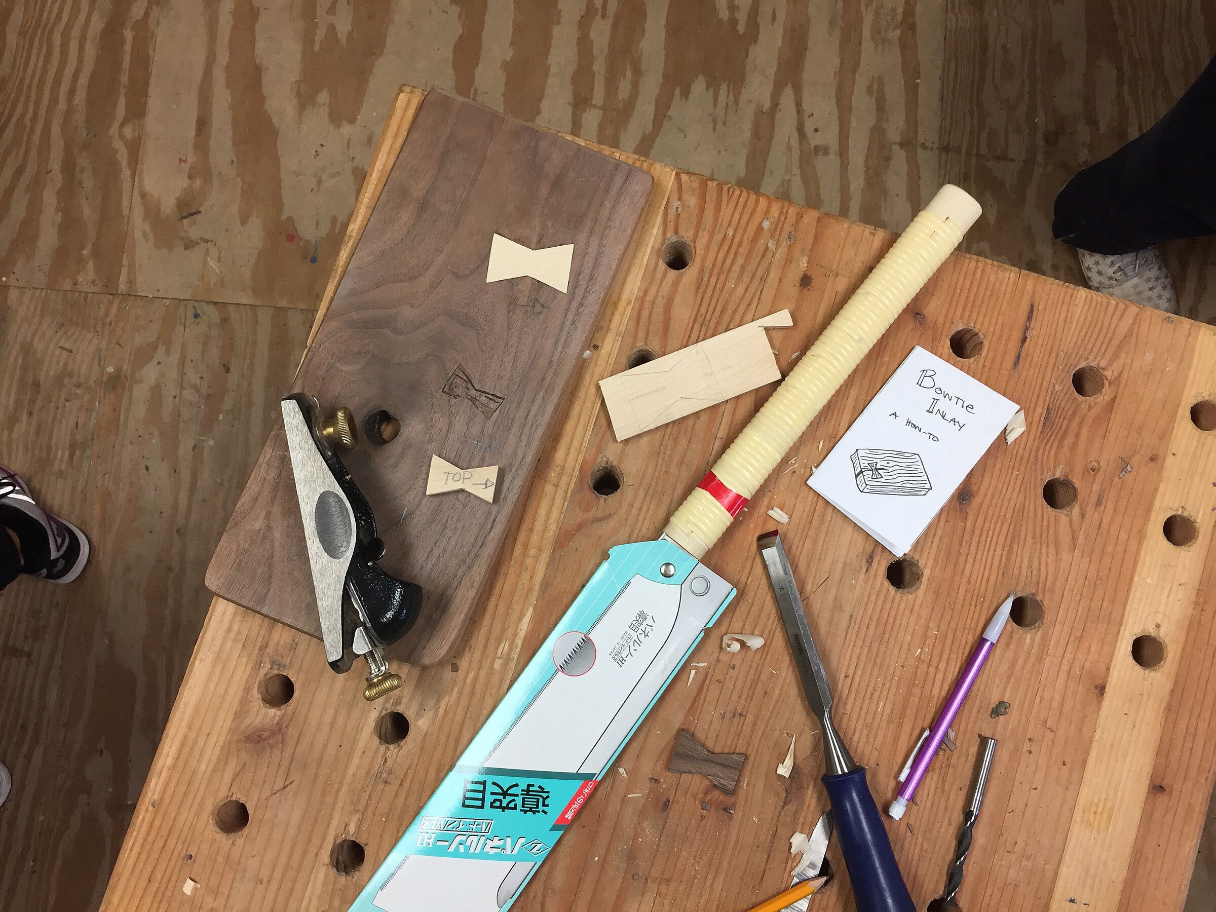 Hands working with tools in a workshop
